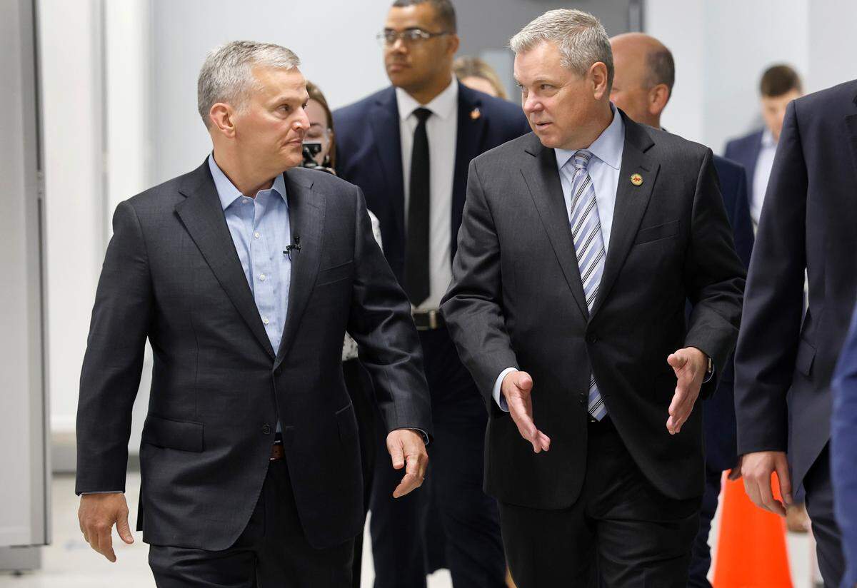 North Carolina Gov. Josh Stein talks with DMV Commissioner Paul Tine as they arrive at the East Raleigh Division of Motor Vehicles office Friday, May, 30, 2025.