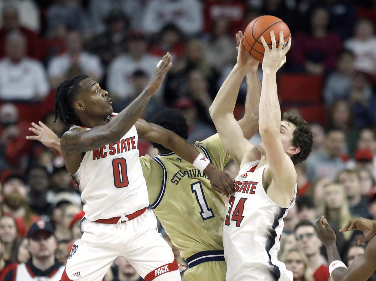 N.C. State’s Ben Middlebrooks (34) pulls down a defensive rebound during the first half of the Wolfpack’s game against Georgia Tech on Saturday, Feb. 3, 2024, at PNC Arena in Raleigh, N.C.