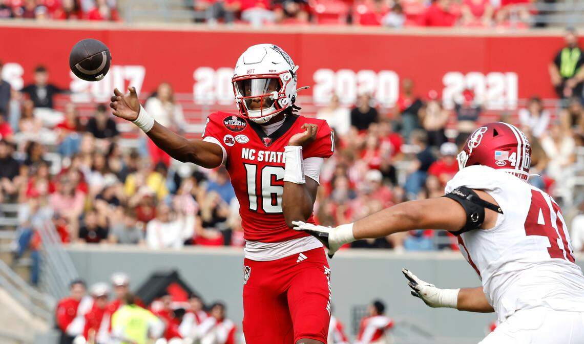 N.C. State quarterback CJ Bailey (16) passes as Stanford defensive lineman Tobin Phillips (40) closes in during the first half of N.C. State’s game against Stanford at Carter-Finley Stadium in Raleigh, N.C., Saturday, Nov. 2, 2024.