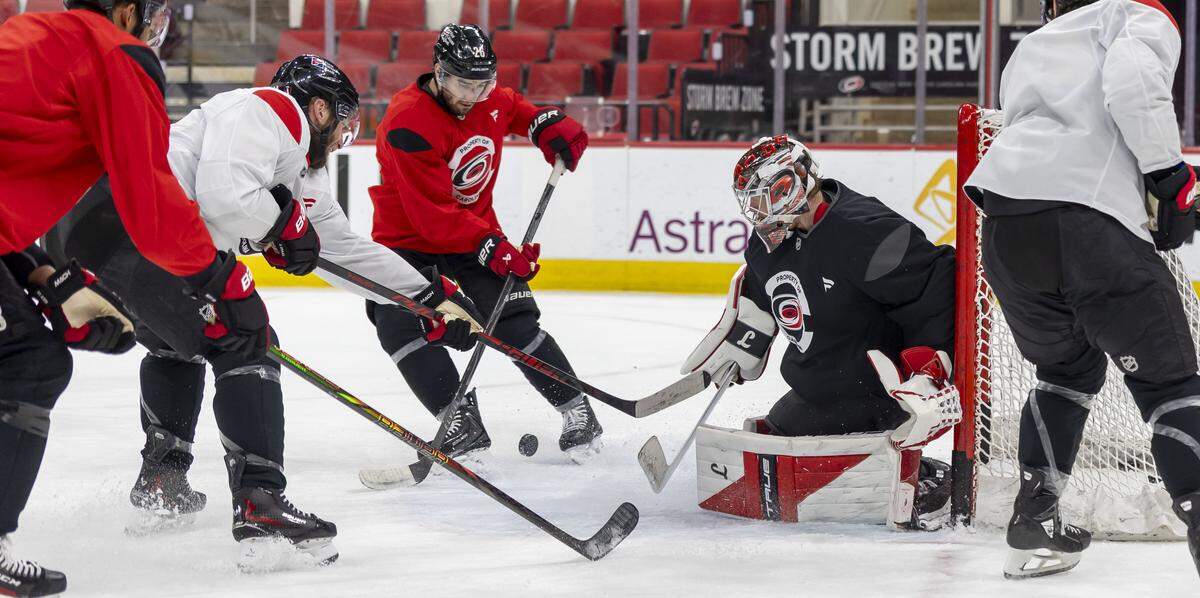 Carolina Hurricanes goalie Frederik Andersen (31) deflects a scoring attempt by center Jordan Staal (11) during practice on Friday, May 15, 2026 at Lenovo Center in Raleigh, N.C.