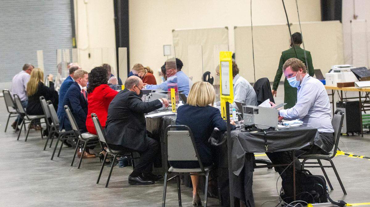 State Board of Elections workers help candidates file for federal, state and local races at the NC State Fairgrounds Monday, Dec. 6, 2021. A court order Monday temporarily blocked U.S. House, state Senate and state House seat candidates from filing to run in the 2022 elections under the districts drawn by Republican state lawmakers.