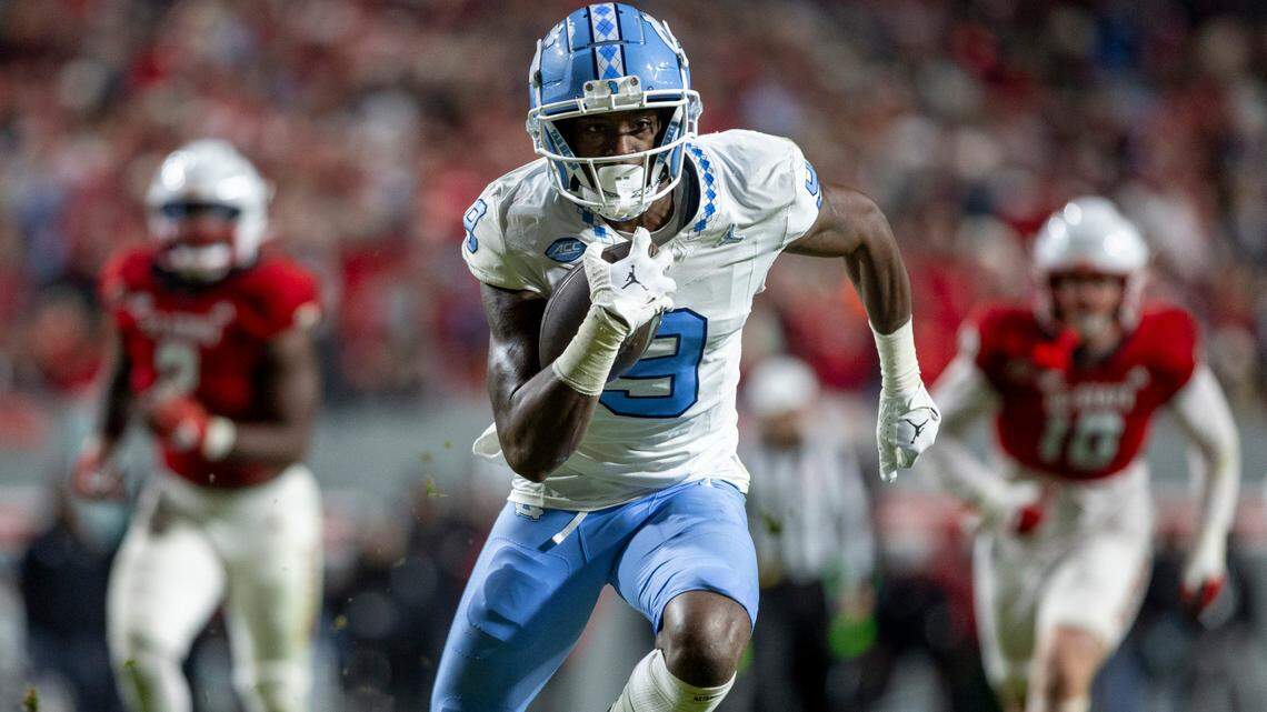 North Carolina’s Devontez Walker (9) scores on a 21-yard pass completion from quarterback Drake Maye in the third quarter against N.C. State on Saturday, November 25, 2023 at Carter-Finley Stadium in Raleigh, N.C.