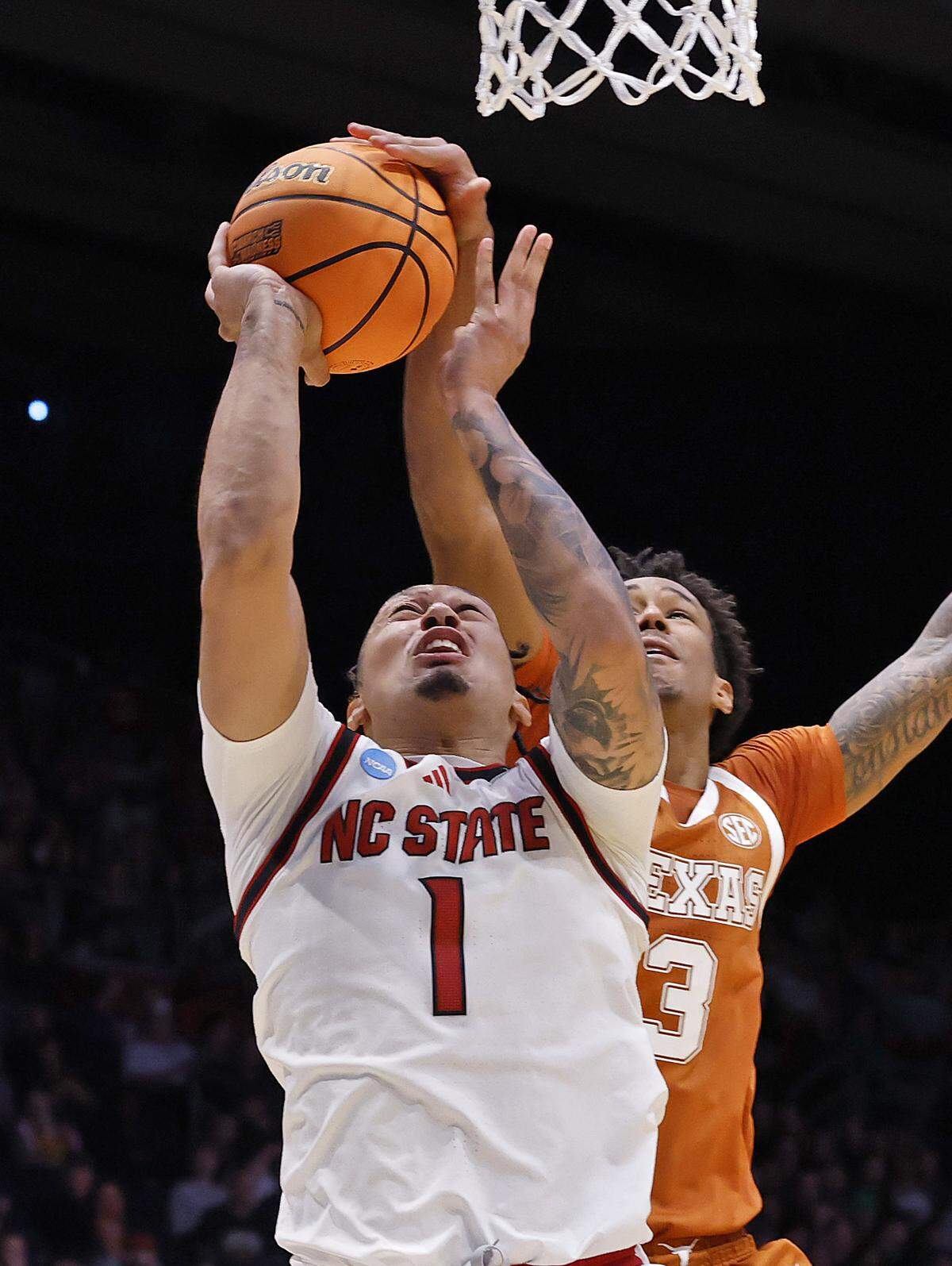 Texas’ Dailyn Swain blocks a shot by N.C. State’s Darrion Williams during the first half of the Wolfpack’s game during the NCAA First Four on Tuesday, March 17, 2026, at the University of Dayton Arena in Dayton, Ohio. 