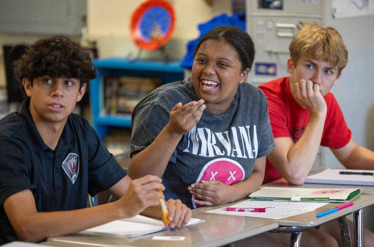 Wakefield High School Jakyra Bridges, center, asks teacher Anthony Calabria a question during speech class on Tuesday, September 3, 2024 in Raleigh, N.C.