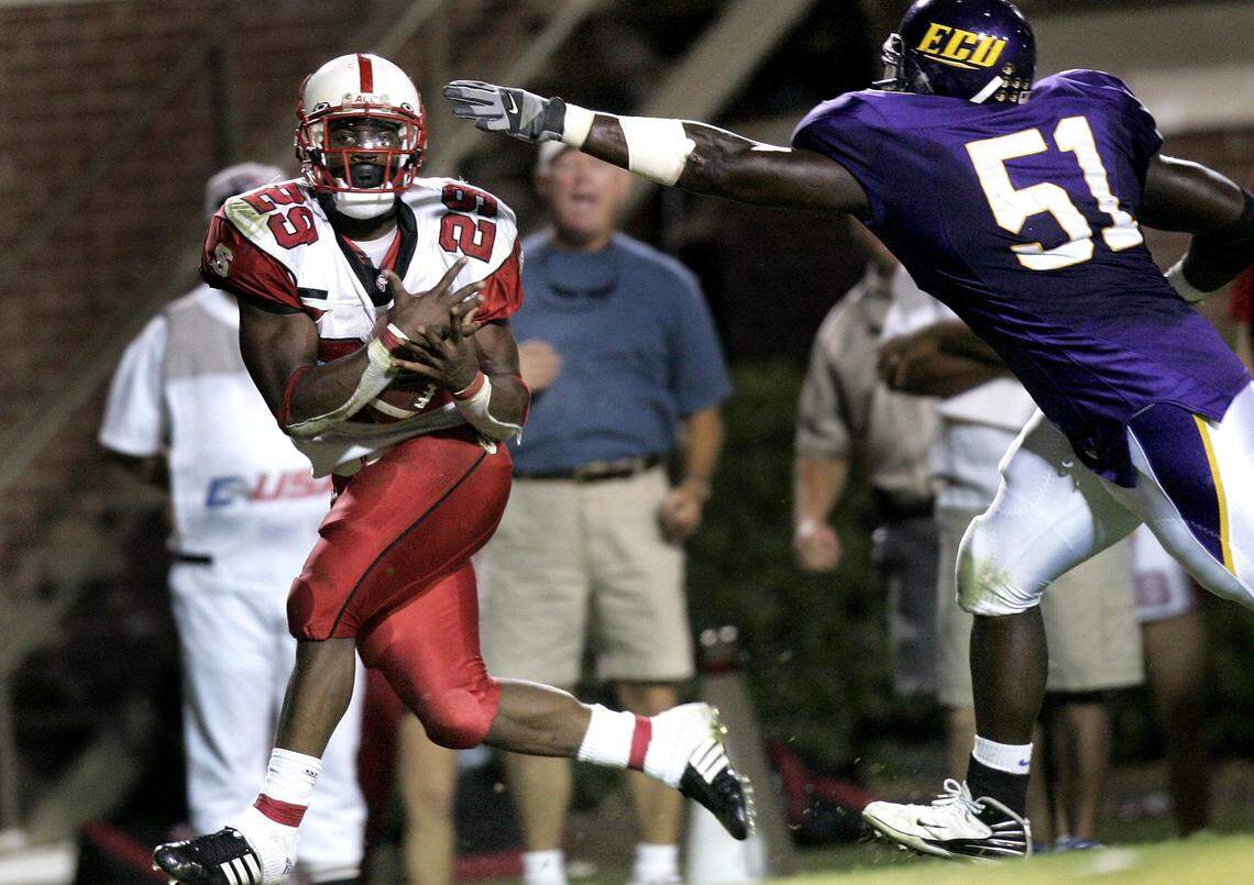 N.C. State’s Jamelle Eugene (29) catches a touchdown pass as ECU’s Fred Wilson (51) defends during the Wolfpack’s 34-20 victory over ECU at Dowdy-Ficklen Stadium in 2007.