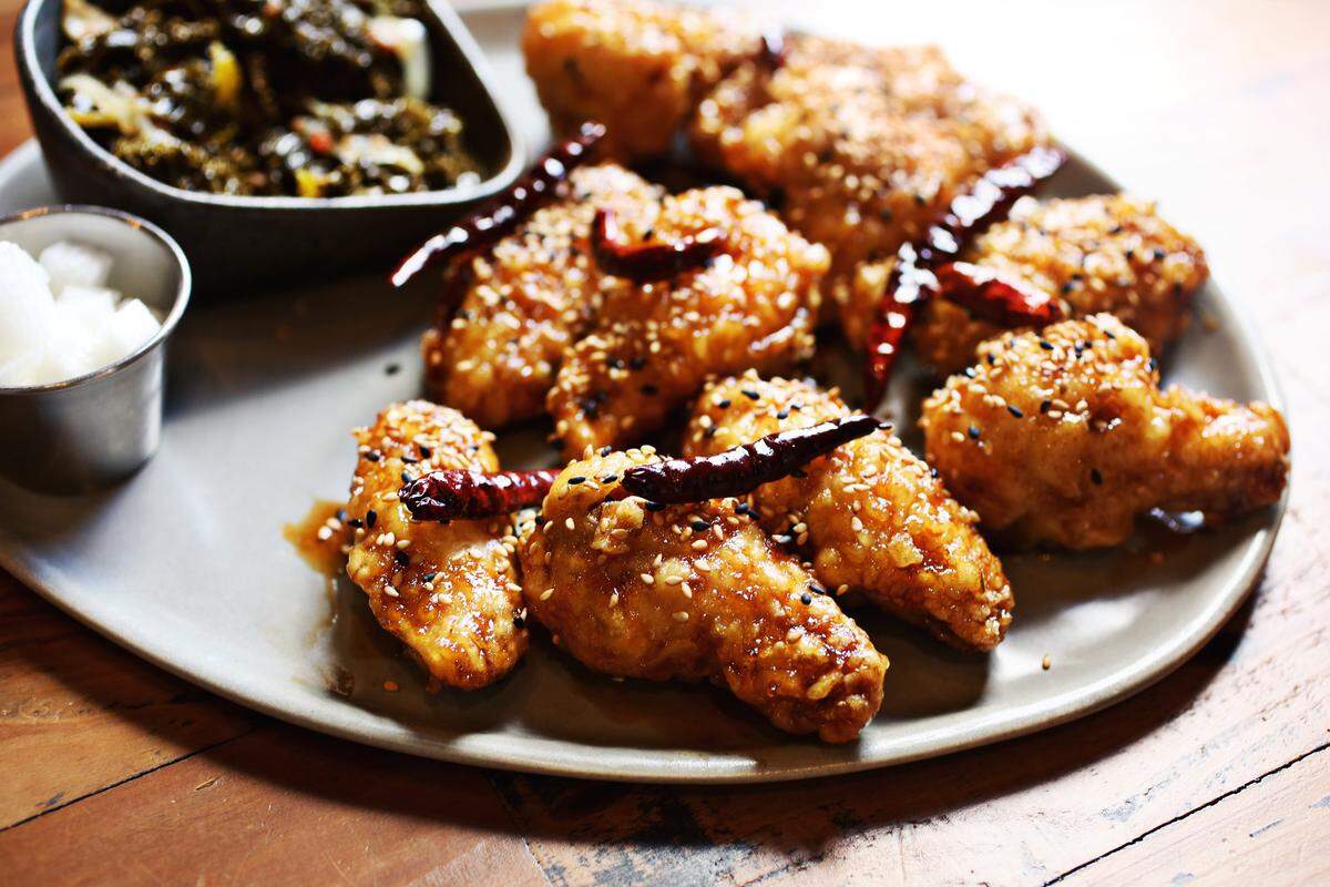 The house specialty at M Kokko is KFC wings, the K standing for Korean as in that countrys famously extra-crispy twice-fried chicken. Twelve bucks gets you eight wings, glazed with a classic soy-garlic sauce or a spicy-sweet sauce riddled with freshly toasted red chiles. That price also gets you a small dish of house-pickled daikon and a seasonal vegetable side sautéed kale.