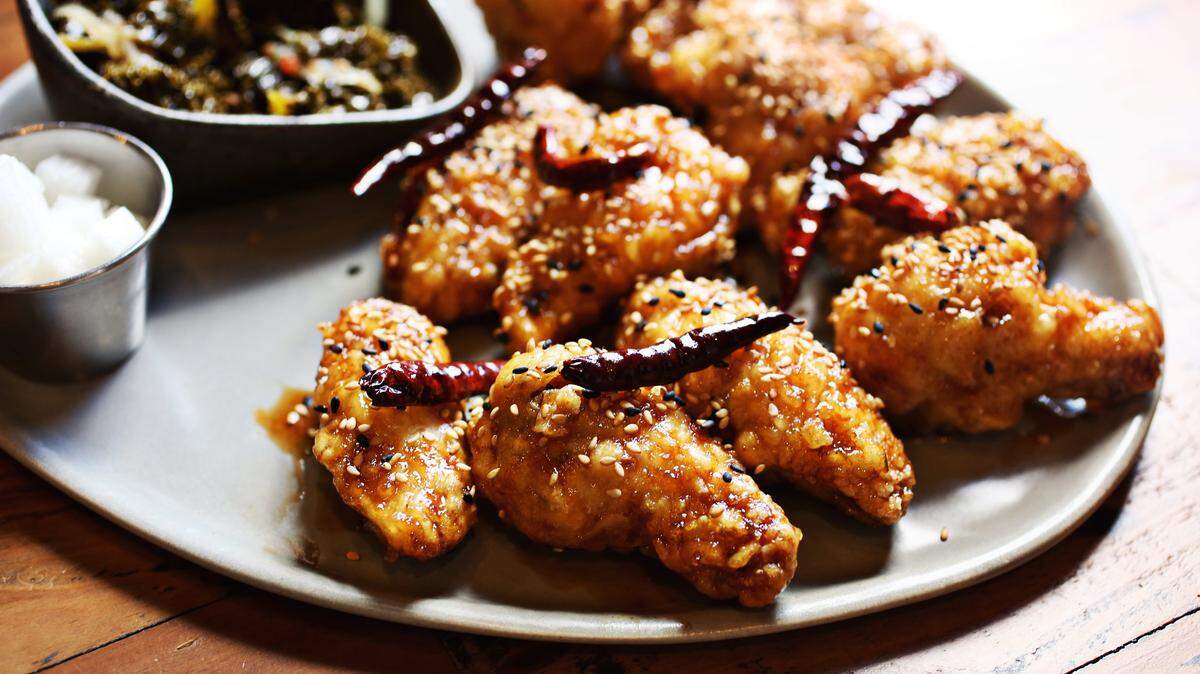 The house specialty at M Kokko is KFC wings, the K standing for Korean  as in that countrys famously extra-crispy twice-fried chicken. Twelve bucks gets you eight wings, glazed with a classic soy-garlic sauce or a spicy-sweet sauce riddled with freshly toasted red chiles. That price also gets you a small dish of house-pickled daikon and a seasonal vegetable side  sautéed kale.