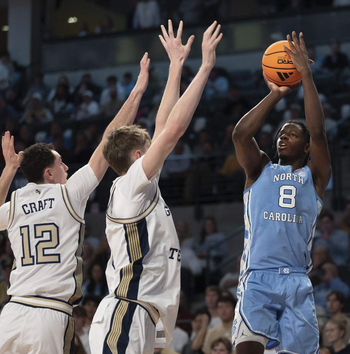 North Carolina forward Caleb Wilson (8) puts up a three point shot over Georgia Tech guard Kam Craft (12) and center Cole Kirouac (8) in the second half on Saturday, January 31, 2026 at McCamish Pavillon in Atlanta Ga.