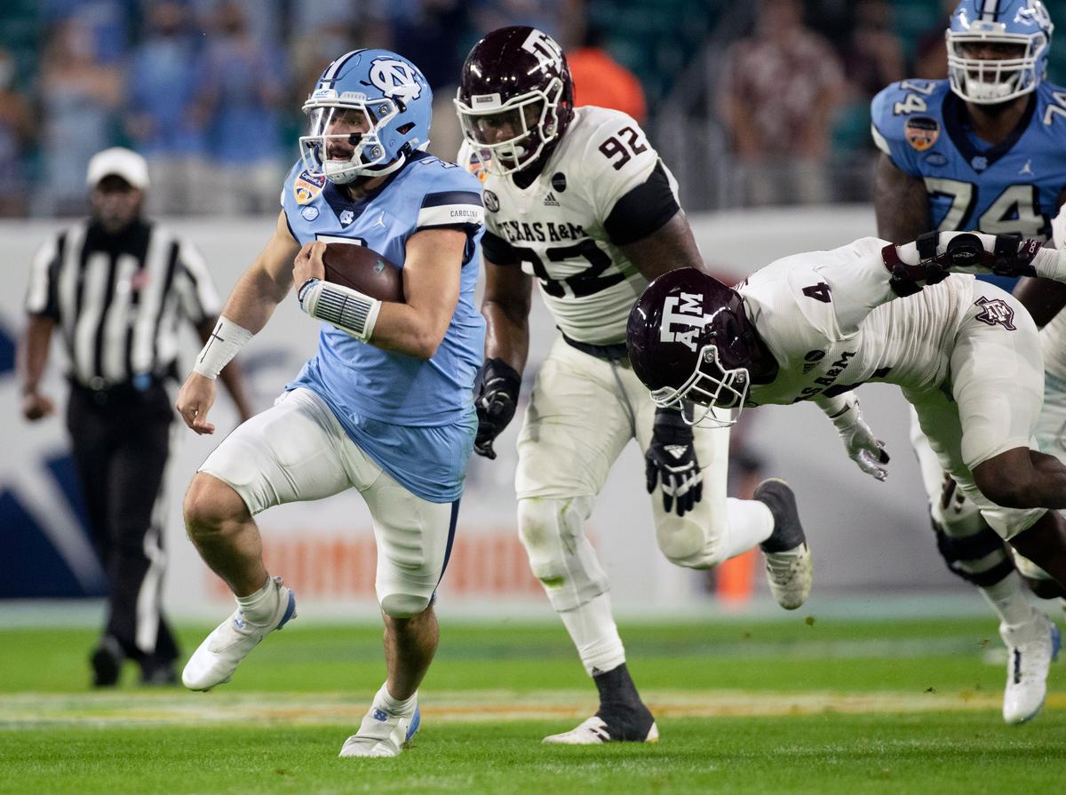 North Carolina quarterback Sam Howell (7) carries the ball for 15 yards and a first down in the second quarter against Texas A&M in the Capital One Orange Bowl on Saturday, January 2, 2021in Miami Gardens, Florida.