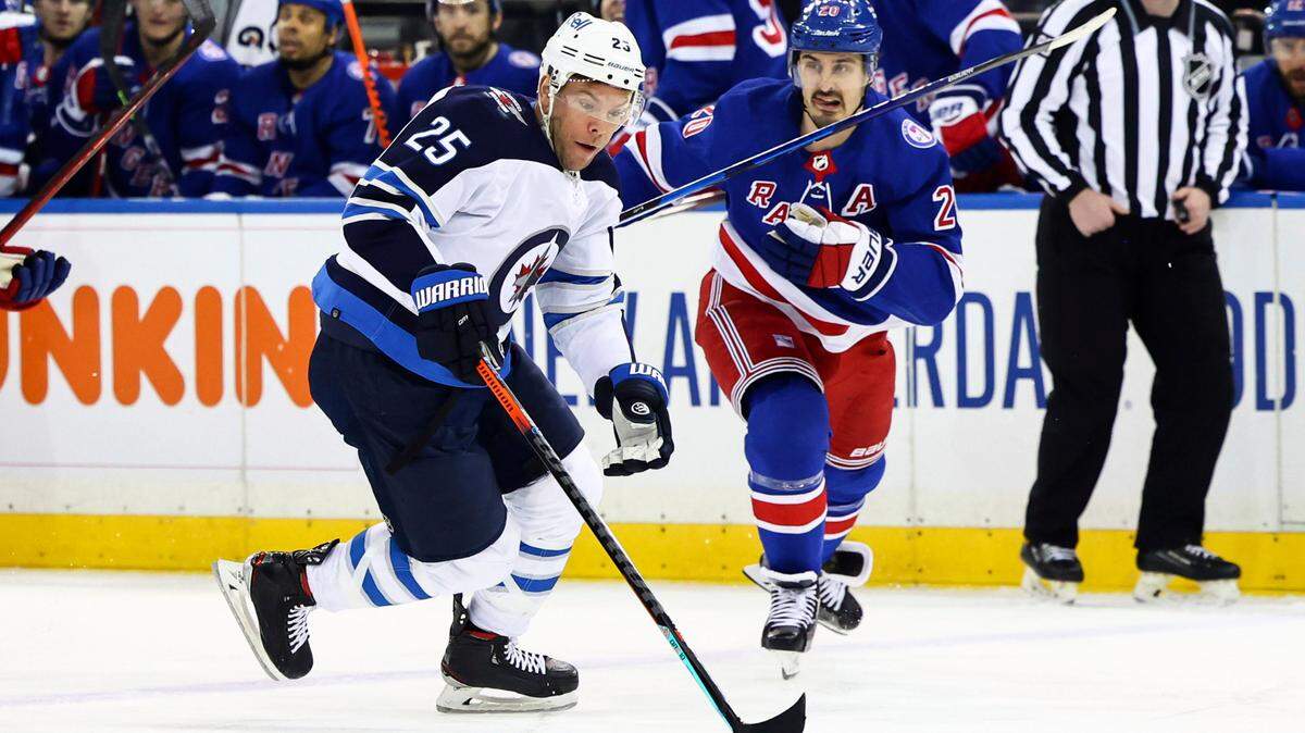 Winnipeg Jets center Paul Stastny (25) skates with the puck against New York Rangers left wing Chris Kreider (20) during the first period of an NHL hockey game Tuesday, April 19, 2022, in New York. (AP Photo/Jessie Alcheh)