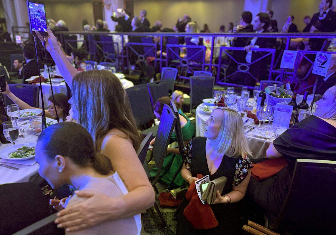Guests watch from tables after U.S. President Donald Trump and first lady Melania Trump were rushed out of the White House Correspondents' Association dinner by Secret Service agents after a loud, unidentified noise, in Washington, D.C., U.S. April 25, 2026. Picture taken using a mobile phone. REUTERS/Jessica Koscielniak REFILE - QUALITY REPEAT     TPX IMAGES OF THE DAY