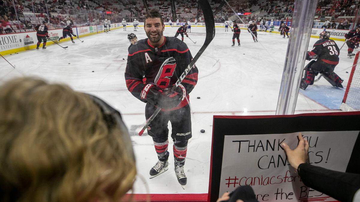 Carolina Hurricane’s Jordan Martinook greets twelve-year-old Emma Izzo, left, of New Bern, N.C. during the Carolina Hurricanes’ pre-game skate prior to their game against Tampa Bay on Sunday, May 30, 2021 at PNC Arena in Raleigh, N.C.