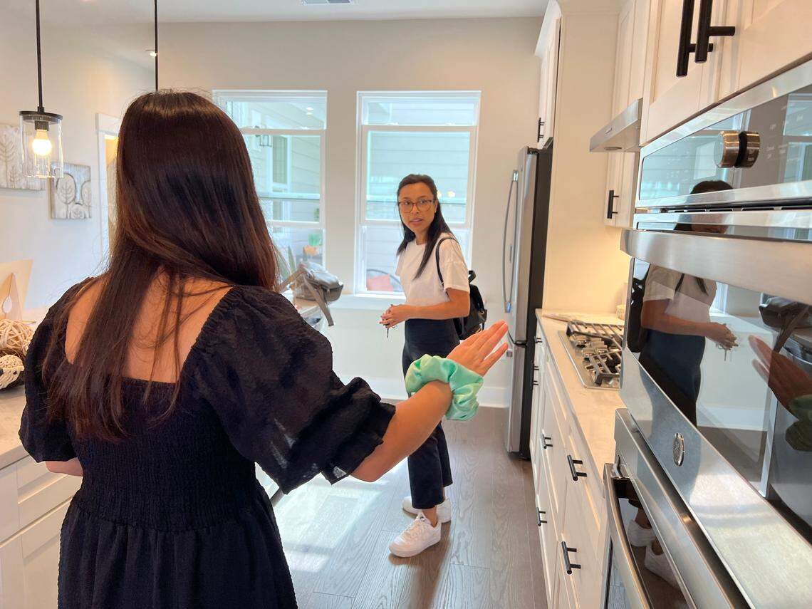 Olivia Slay looks for a starter home with her friend in Chatham Park at this year’s Triangle Parade of Homes on Sunday.