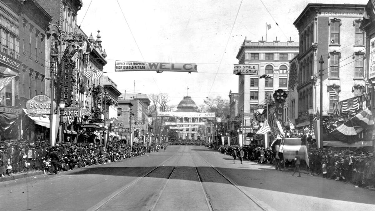 A parade on Raleigh’s Fayetteville Street in 1918 welcoming home 113th Field Artillery following World War l. Note the electric streetcar tracks running down Fayetteville Street.  Raleigh’s streetcars stopped operating in 1933 and many tracks were removed or paved over.