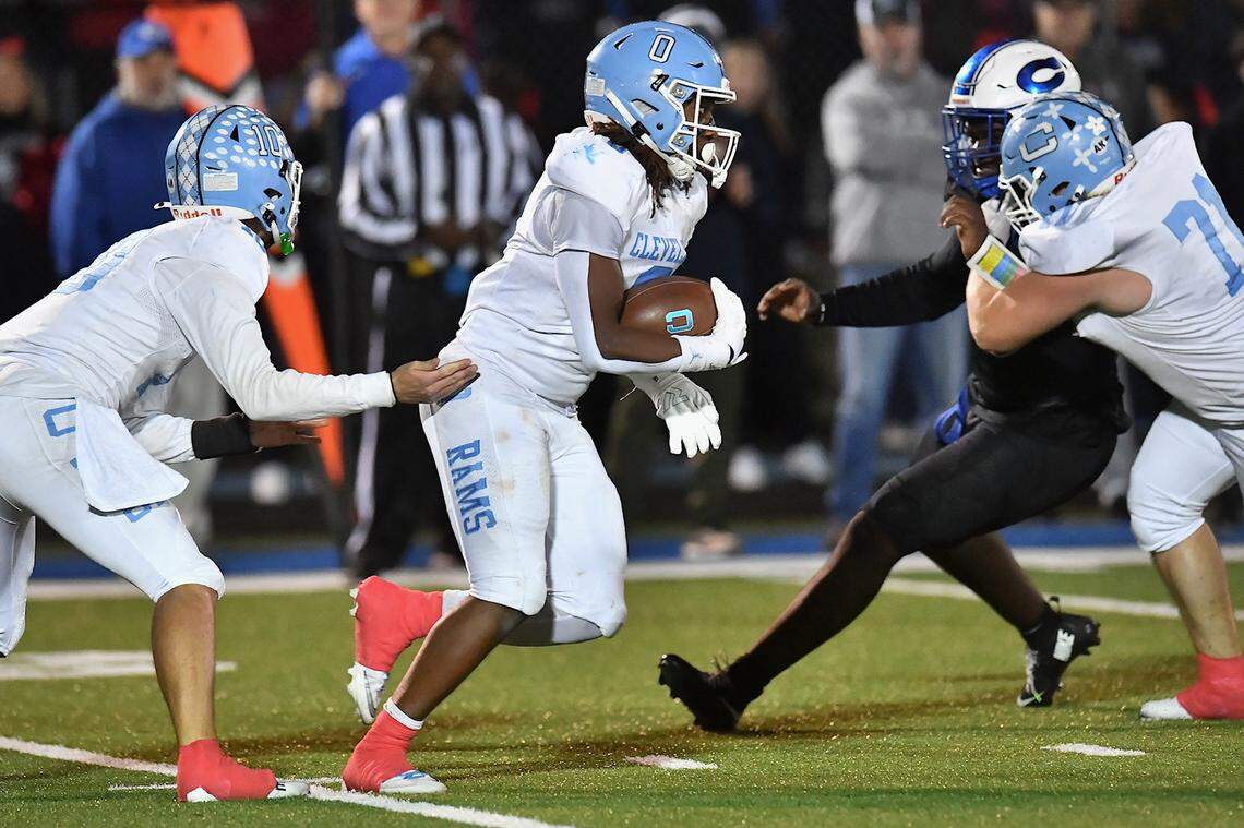 Cleveland running back Kaleb Ferrell (0) runs for yardage from the handoff from quarterback Owen Hulbert (10) during the second half. The Cleveland Rams took on the Clayton Comets in a conference football game in Clayton, N.C. on October 31st in Clayton, N.C.