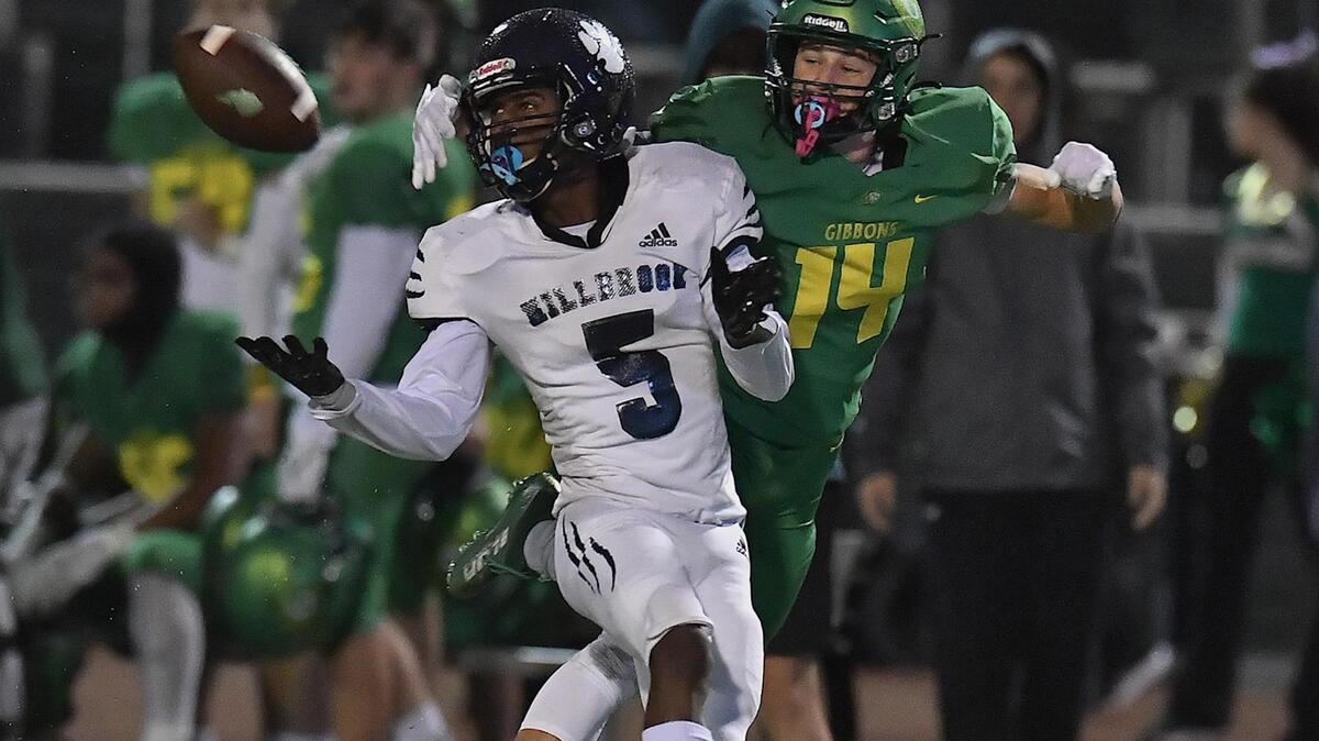 Millbrook’s Session McArthur (5) attempts the interception against Cardinal Gibbons’ Chey Yardley (14) during the first half. The Cardinal Gibbons Crusaders and the Millbrook Wildcats met in a NCHSAA 4A playoff game in Raleigh, NC on November 10, 2022