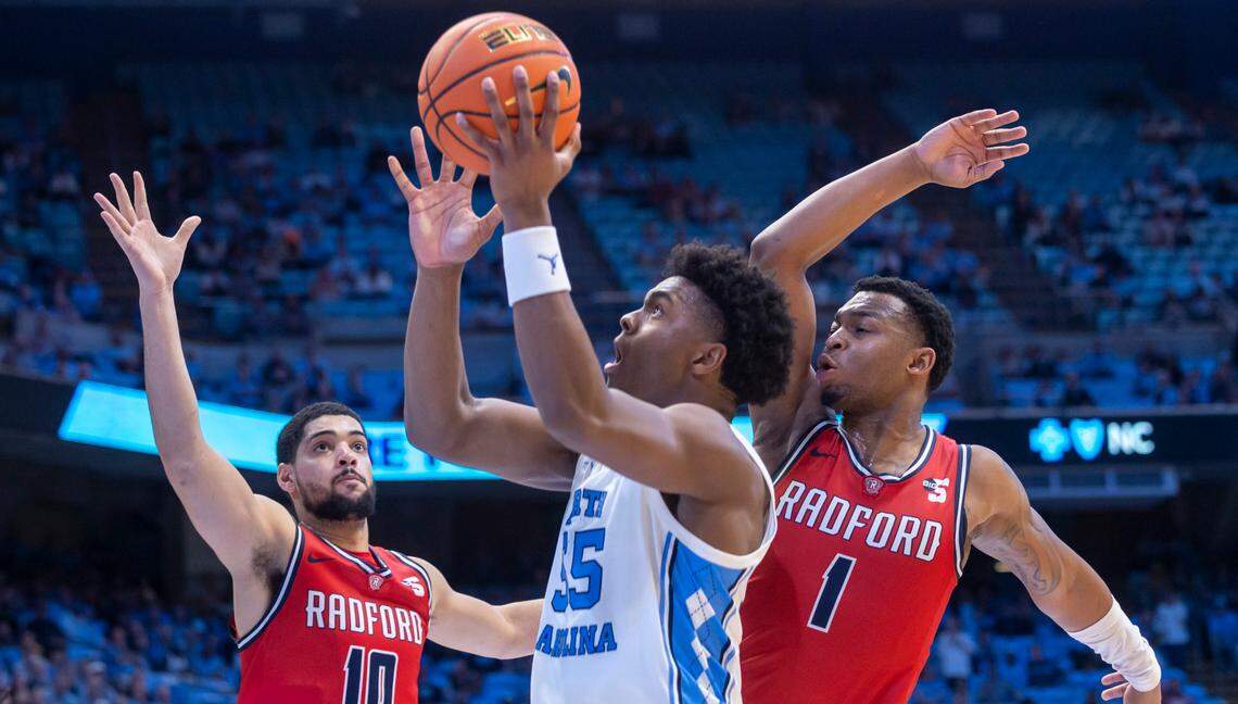 North Carolina’s Harrison Ingram (55) puts up a shot against Radford’s Chandler Turner (10) and Daquan Smith (1) in the second half on Monday, November 6, 2023 at the Dean Smith Center in Chapel Hill, N.C.