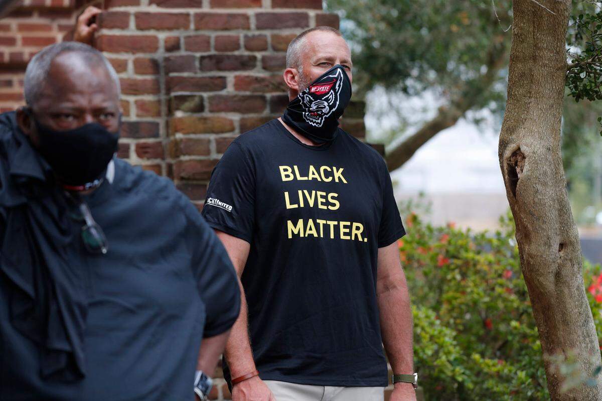 N.C. State football coach Dave Doeren listens during a #PackUnited peaceful protest against racial and social injustice outside Holladay Hall on the campus of N.C. State Saturday, Sept. 12, 2020.