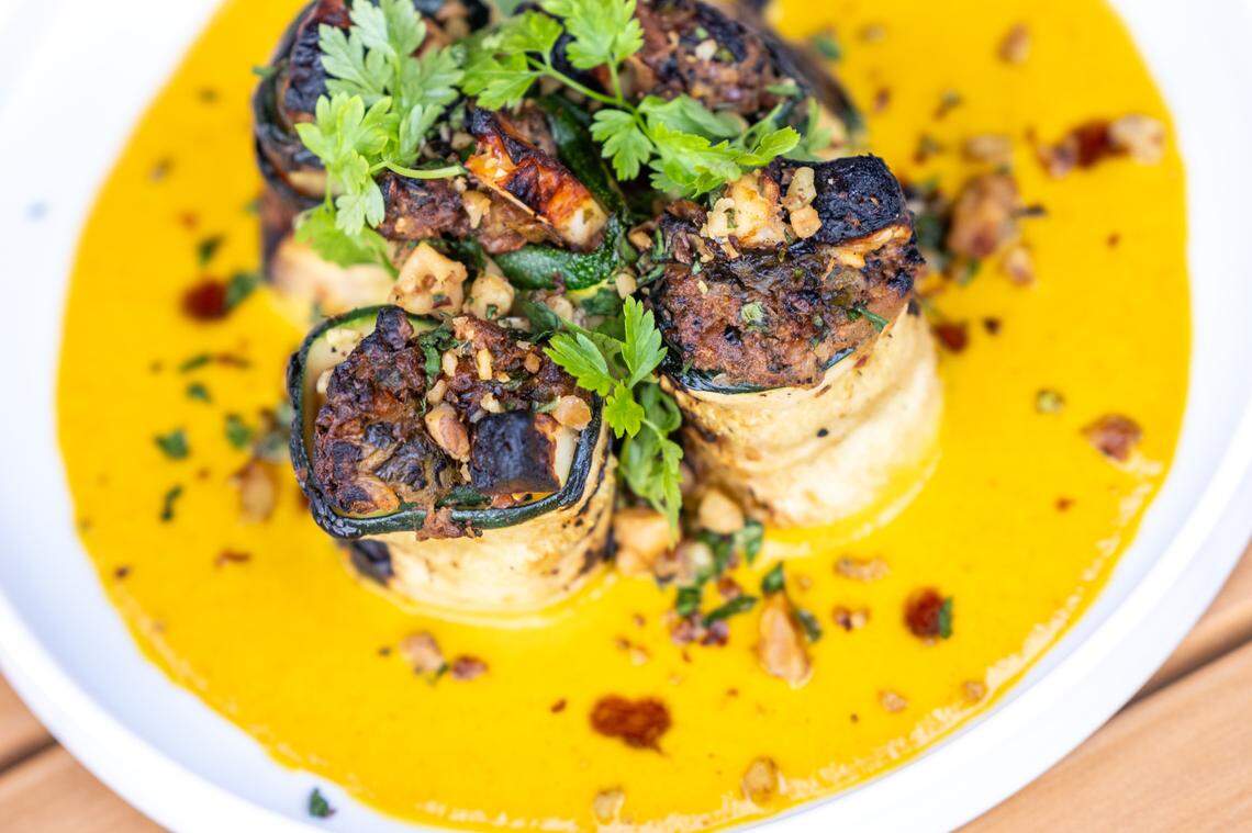 Stuffed summer squash featuring walnut, halloumi, herbs, saffron-tomato sauce during a soft opening Thursday June 15, 2023 at Ajja, a new restaurant from Cheetie Kumar and Paul Siler in on Bickett Blvd. in Raleigh. Ajja focuses on Mediterranean, Middle Eastern and Southwest Asian flavors.