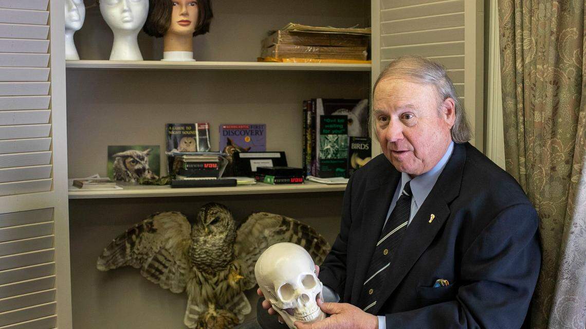 Durham attorney Larry Pollard uses a skull to show how he believes the talons of an owl penetrated the skull of Kathleen Peterson, causing her death in 2001, during an interview in his office on Wednesday, April 27, 2022 in Durham, N.C.