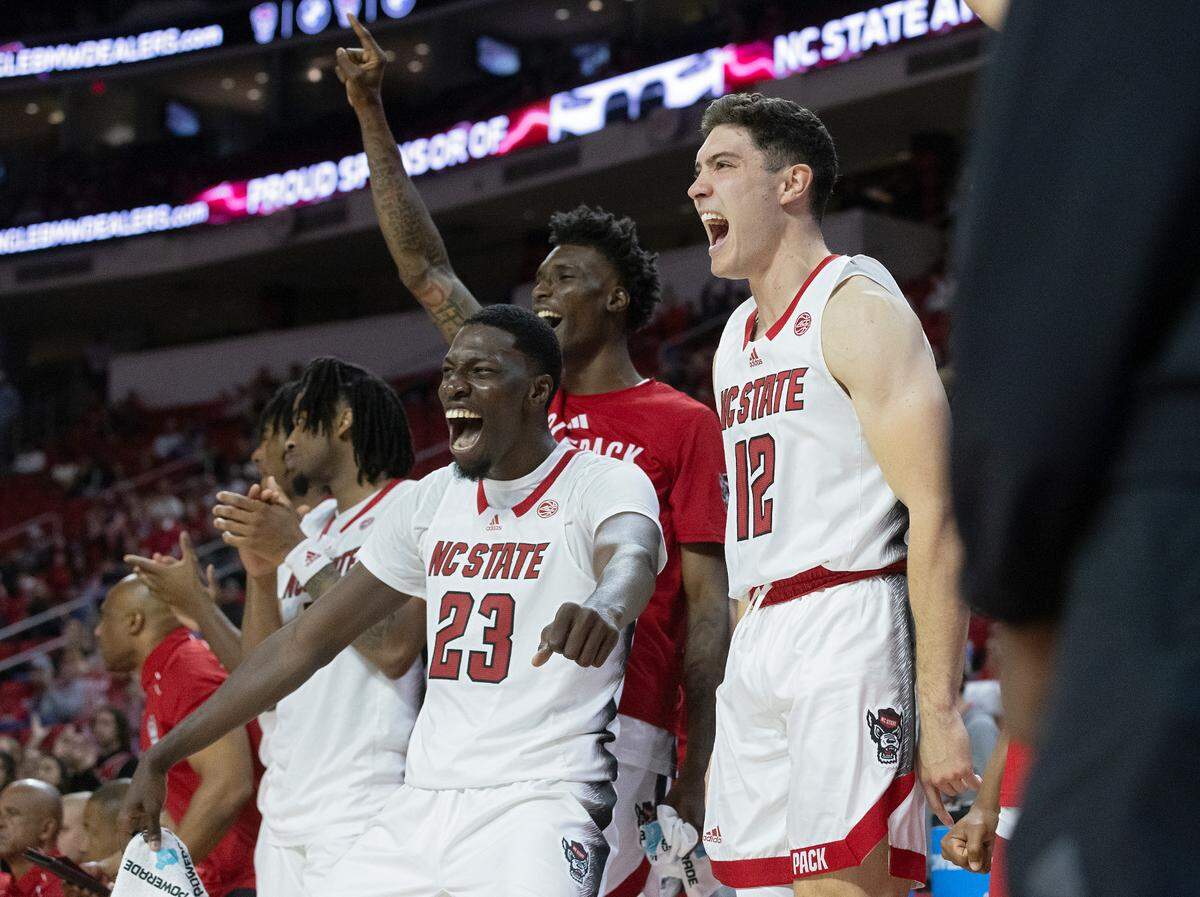 N.C. State’s Mohamed Diarra and Michael O’Connell react following a dunk by teammate Casey Morsell during the second half of the Wolfpack’s 72-59 win over The Citadel on Monday, Nov. 6, 2023, at PNC Arena in Raleigh, N.C.