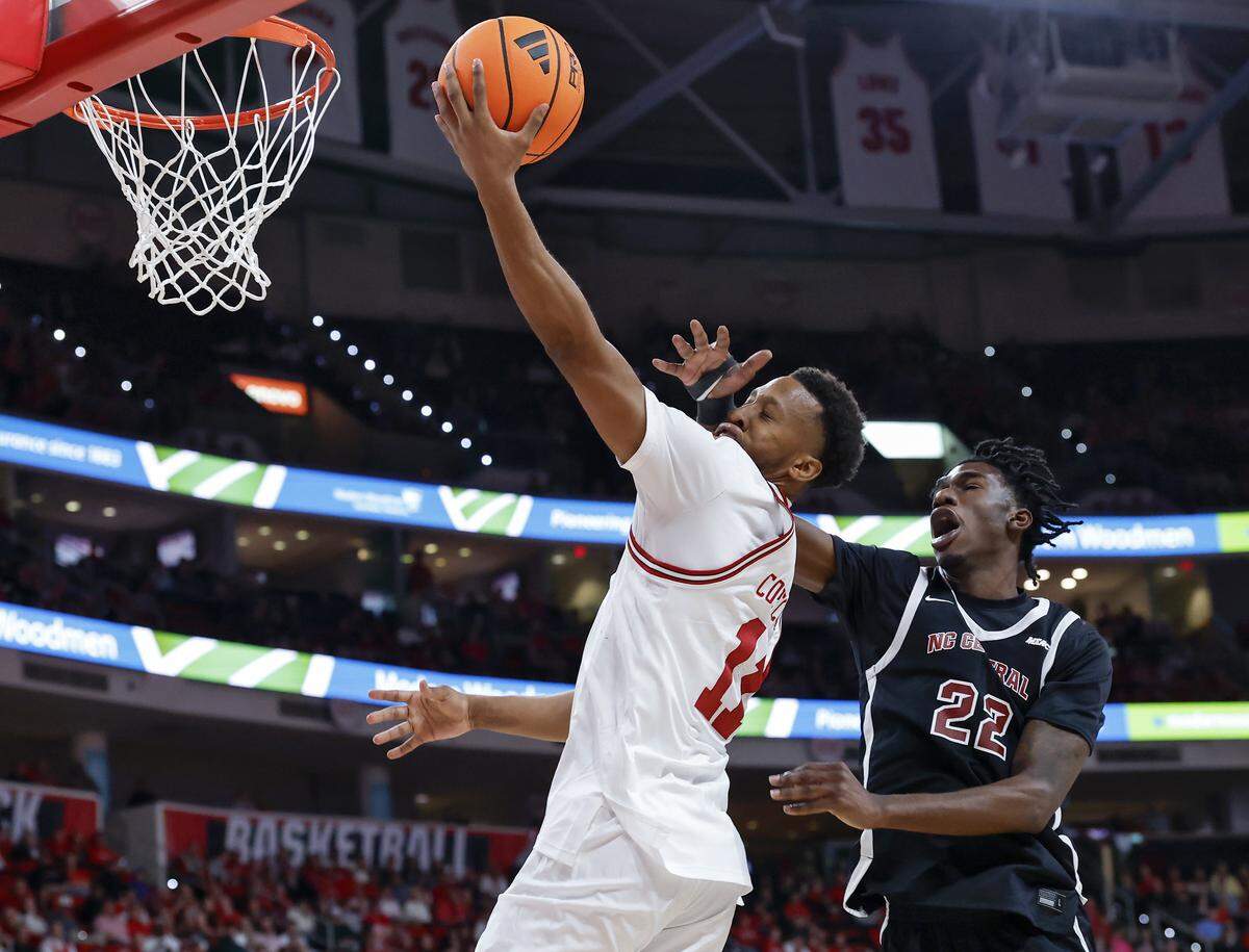 N.C. State’s Quadir Copeland drives to the basket as he is fouled by North Carolina Central’s Ramondo Battle II during the second half of the Wolfpack’s 114-66 win at Lenovo Center on Monday, Nov. 3, 2025, in Raleigh, N.C.