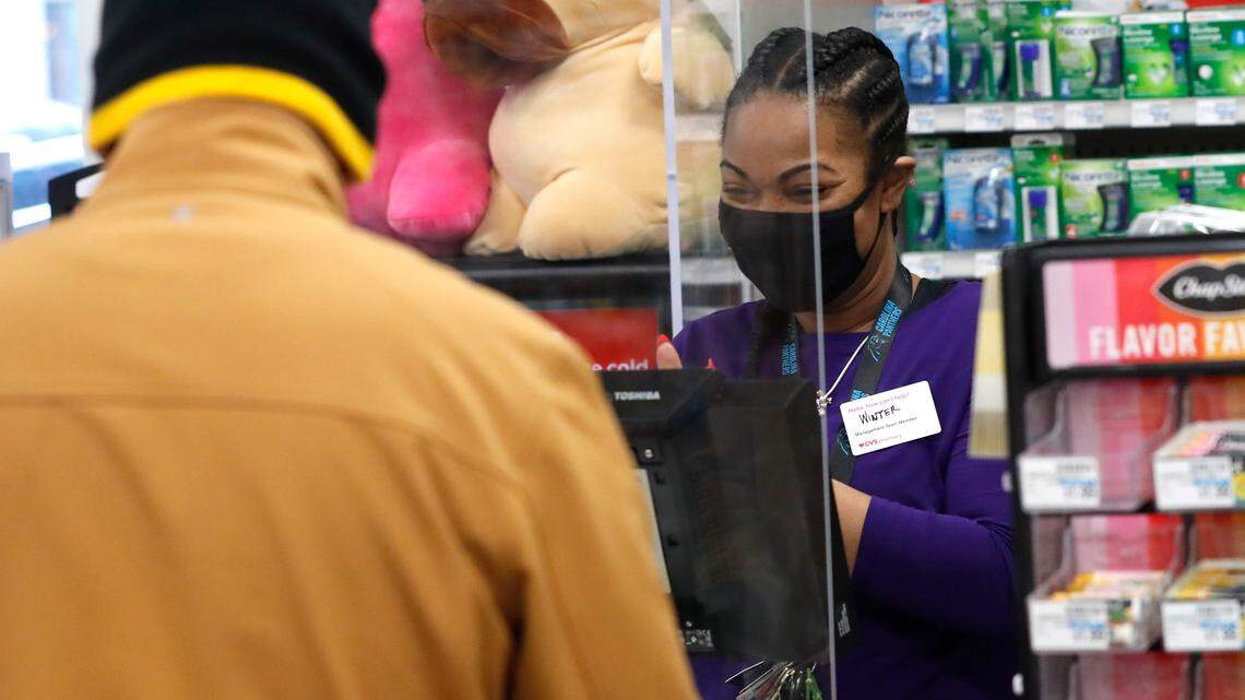 Winter Carter, shift supervisor at the CVS on Fayetteville St. in downtown Raleigh, N.C., smiles as she checks out a customer Friday, February 5, 2021. The CVS store reopened this week after being closed since the end of May after being looted during protests in downtown Raleigh.