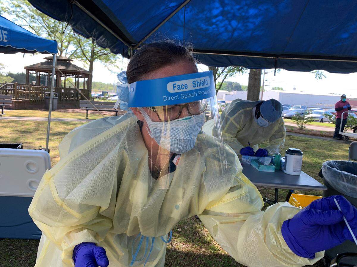 A nurse from the Durham VA's strike team performs a COVID-19 test.