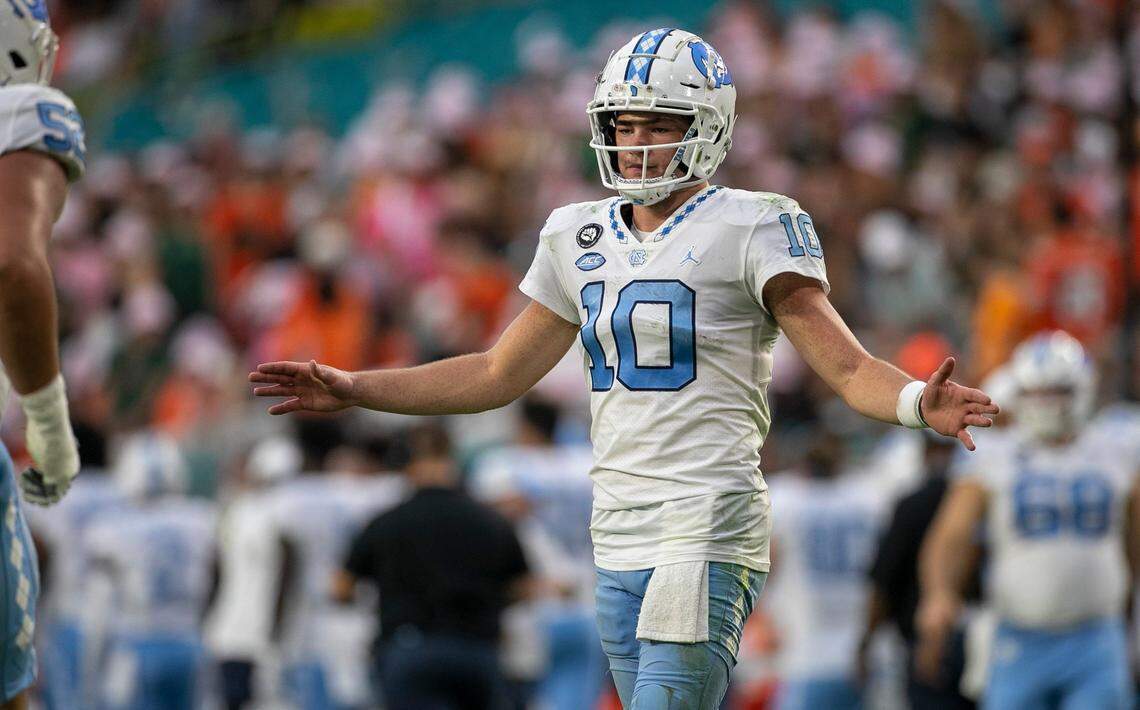 North Carolina quarterback Drake Maye (10) greets the extra point unit after scoring in the second quarter against Miami on Saturday, October 8, 2022 at Hard Rock Stadium in Miami Gardens, Florida.