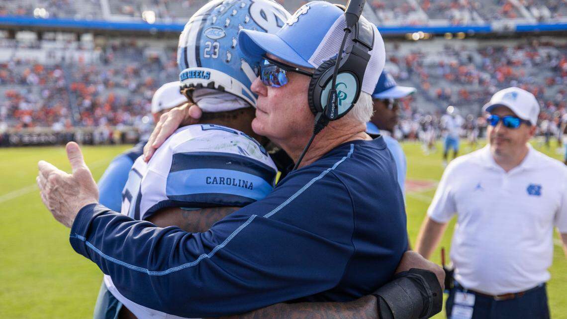 North Carolina coach Mack Brown embraces linebacker Power Echols (23) as they celebrate their 41-14 victory over Virginia on Saturday, October 26, 2024 at Scott Stadium in Charlottesville, Va.