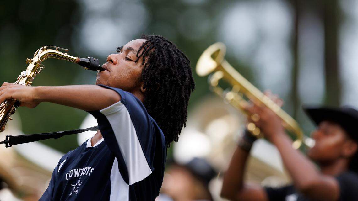 Senior Donyea Smith, left, plays the alto saxophone during the last day of Jordan High School marching band camp on Friday, August 2, 2024, in Durham, N.C.
