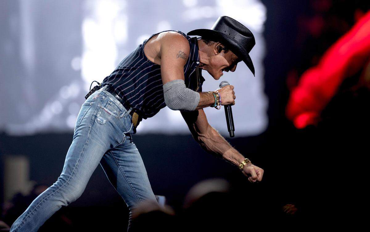 Tim McGraw fist bumps early in his “Standing Room Only Tour” concert at Raleigh, N.C.’s PNC Arena, Saturday, June 22, 2024.