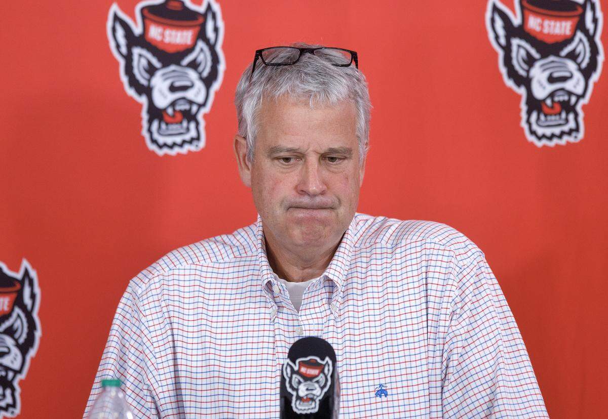 N.C. State Athletic Director Boo Corrigan listens as a reporter asks a question during a press conference at Carter-Finley Stadium on Thursday, March 26, 2026, following the departure of former men’s basketball coach Will Wade.