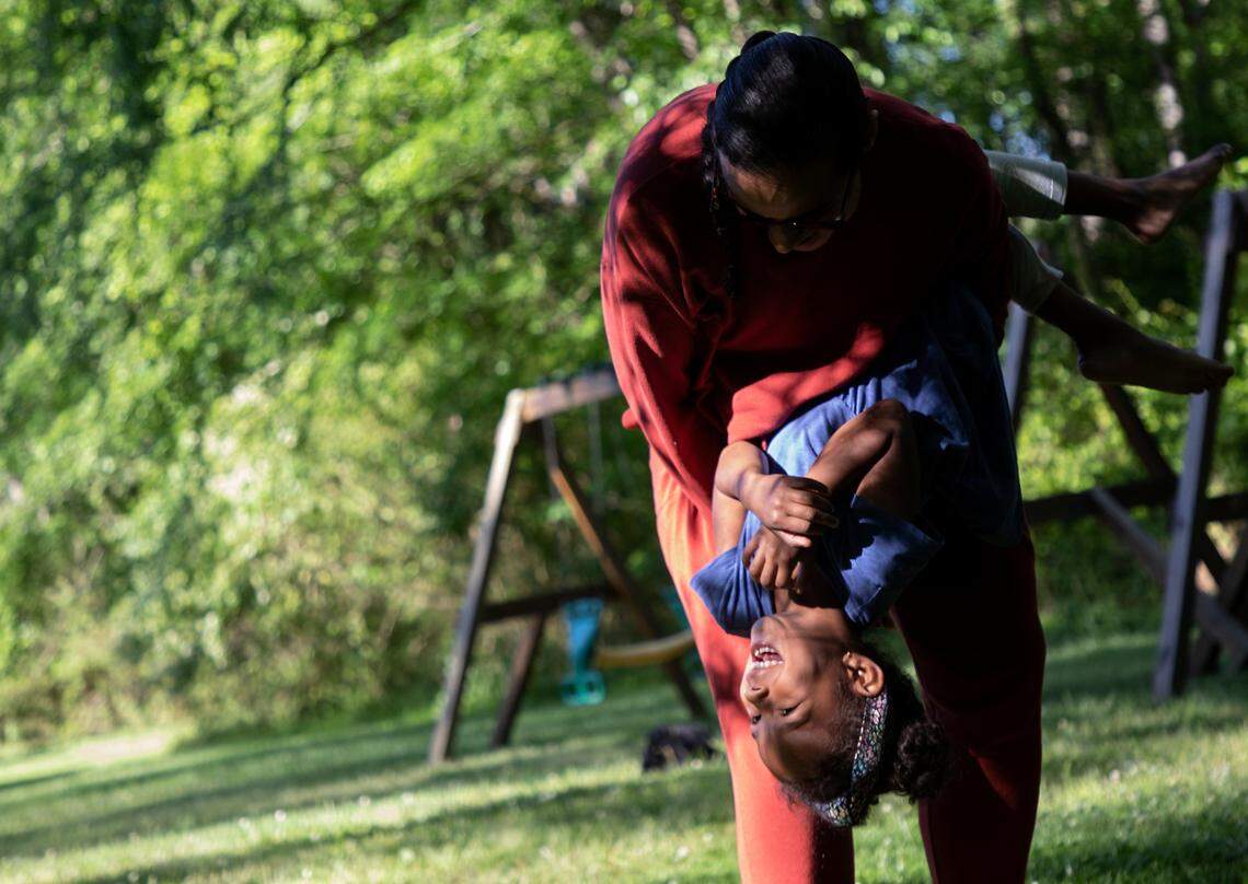 Mavis Daye, 5, laughs as she plays with her mother, Kat Tedford, at a neighborhood park on Monday, May 9, 2022, in Durham, N.C. Tedford and her husband were sued by the Montessori School of Durham over lost tuition payments after they opted not to send their daughter to the school for the 2020-2021 school year due to the COVID-19 pandemic.