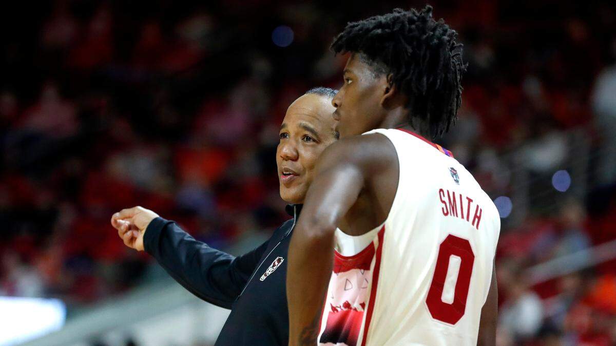 N.C. State head coach Kevin Keatts talks with Terquavion Smith (0) during the second half of Syracuse’s 89-82 victory over N.C. State at PNC Arena in Raleigh, N.C., Wednesday, Feb. 2, 2022.