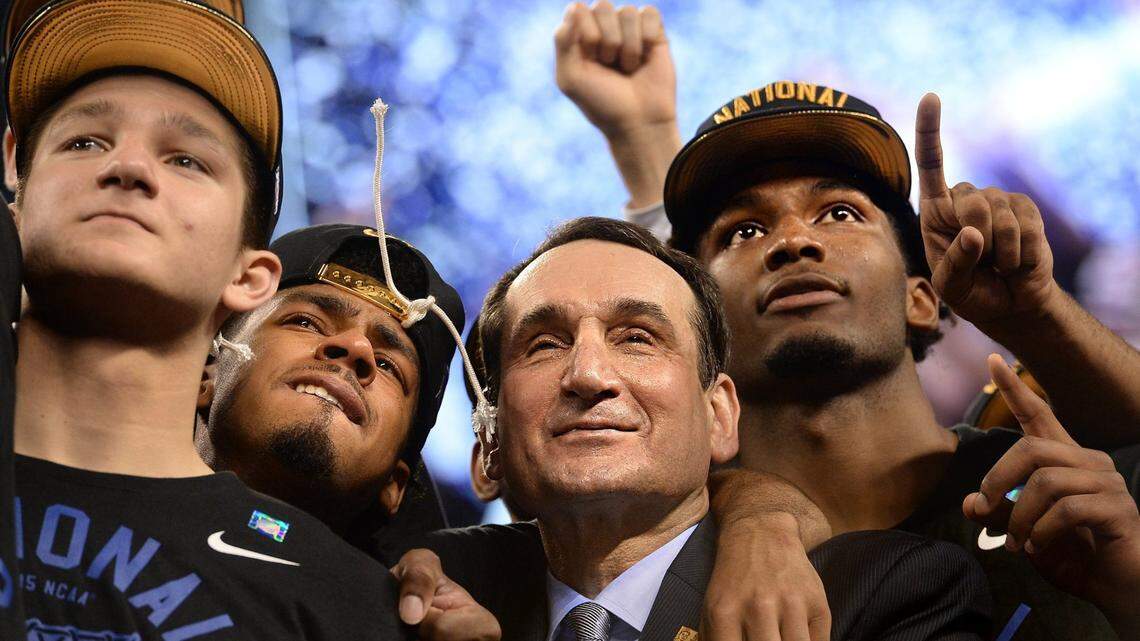 Duke head coach Mike Krzyzewski stands with, left to right, guard Grayson Allen (3), guard Quinn Cook (2) and forward Justise Winslow (12) as they watch “One Shining Moment” after Duke defeated Wisconsin 68-63 for the NCAA national championship in the Final Four at Lucas Oil Stadium at Indianapolis, Indiana, Monday, April 6, 2015.