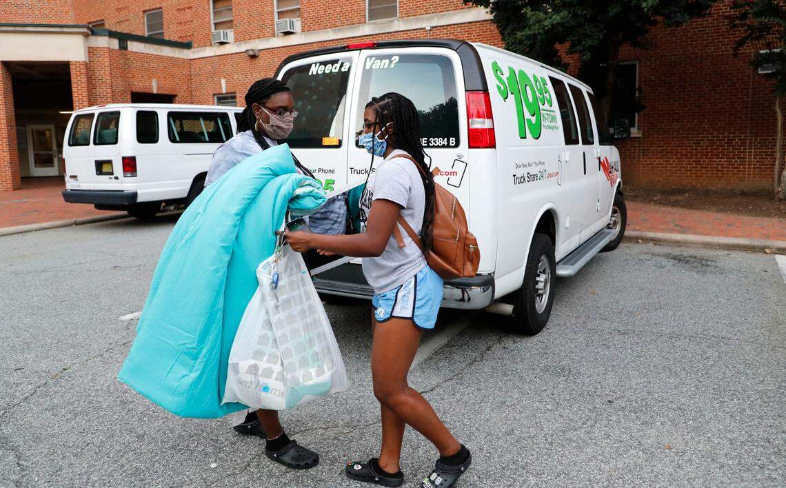 Charisma Sumpter, a freshman at UNC-Chapel Hill from Raleigh, right, gets help from her mother, Shanda, while moving out of her room at Hinton James residence hall in Chapel Hill, N.C., Tuesday, August 18, 2020.
