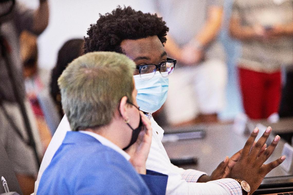 USG Vice President Collyn Smith, left, leans in to speak privately with UNC student body president Lamar Richards, right, during the UNC student government meeting in Chapel Hill with student organization presidents addressing the rise in COVID-related cases on Friday, Sept. 3, 2021.