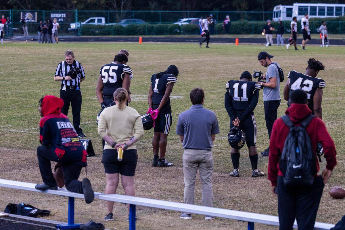 A moment of silence is observed prior to a postponed homecoming football game at Knightdale High School Monday, Oct. 17, 2022 following a mass shooting that left 5 people dead Thursday in Raleigh’s Hedingham neighborhood. James Thompson, 16, a junior at Knightdale High, was one of five people killed in the shooting.