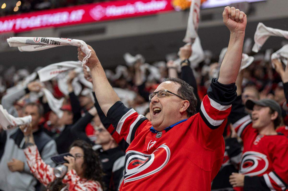 Carolina Hurricanes fan Todd Holmes celebrates following a goal by Shaye Gostisbehere (04) in the first period, to take a 1-0 lead against the Washington Capitals during Game 4 of their series on Monday, May 12, 2025 at Lenovo Center in Raleigh, N.C.