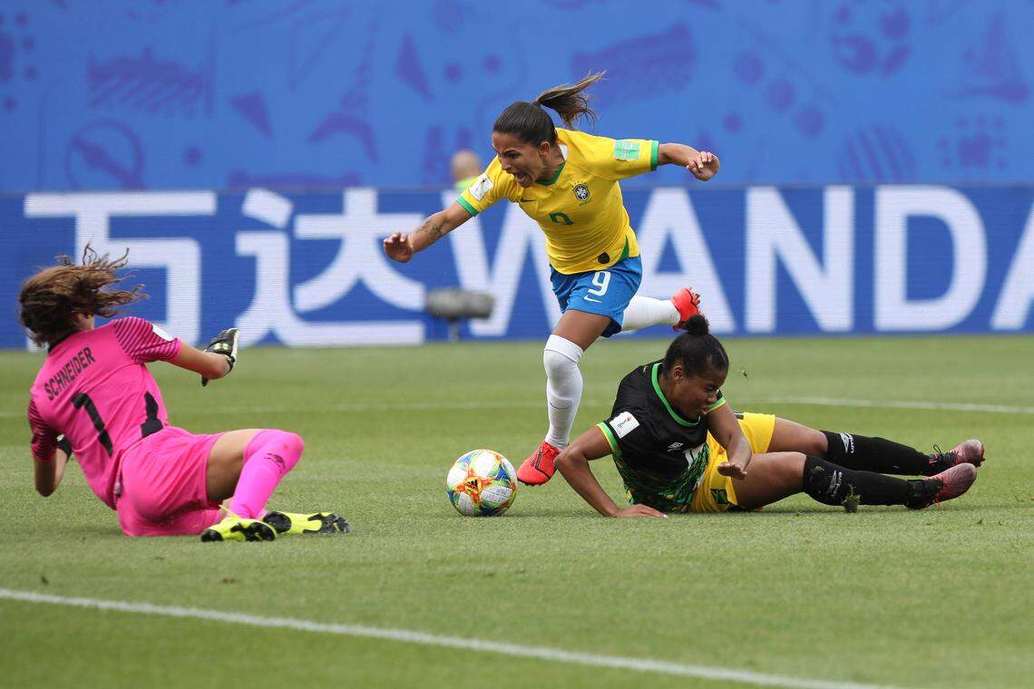 Brazil’s Debinha, center, tries to score past Jamaica goalkeeper Sydney Schneider during the Women’s World Cup Group C soccer match between Brazil and Jamaica in Grenoble, France, Sunday, June 9, 2019. (AP Photo/Laurent Cipriani)
