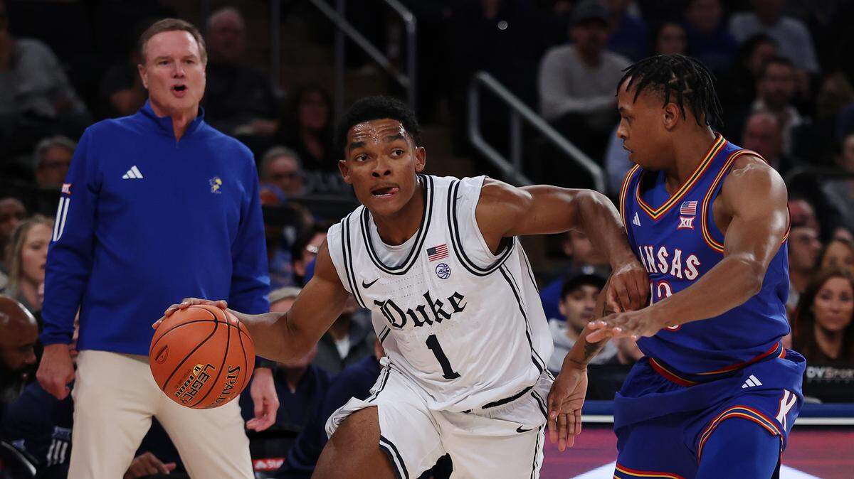 Caleb Foster (1) of the Duke Blue Devils dribbles against Elmarko Jackson (13) of the Kansas Jayhawks during the first half in the 2025 State Farm Champions Classic at Madison Square Garden on November 18, 2025 in New York City.  