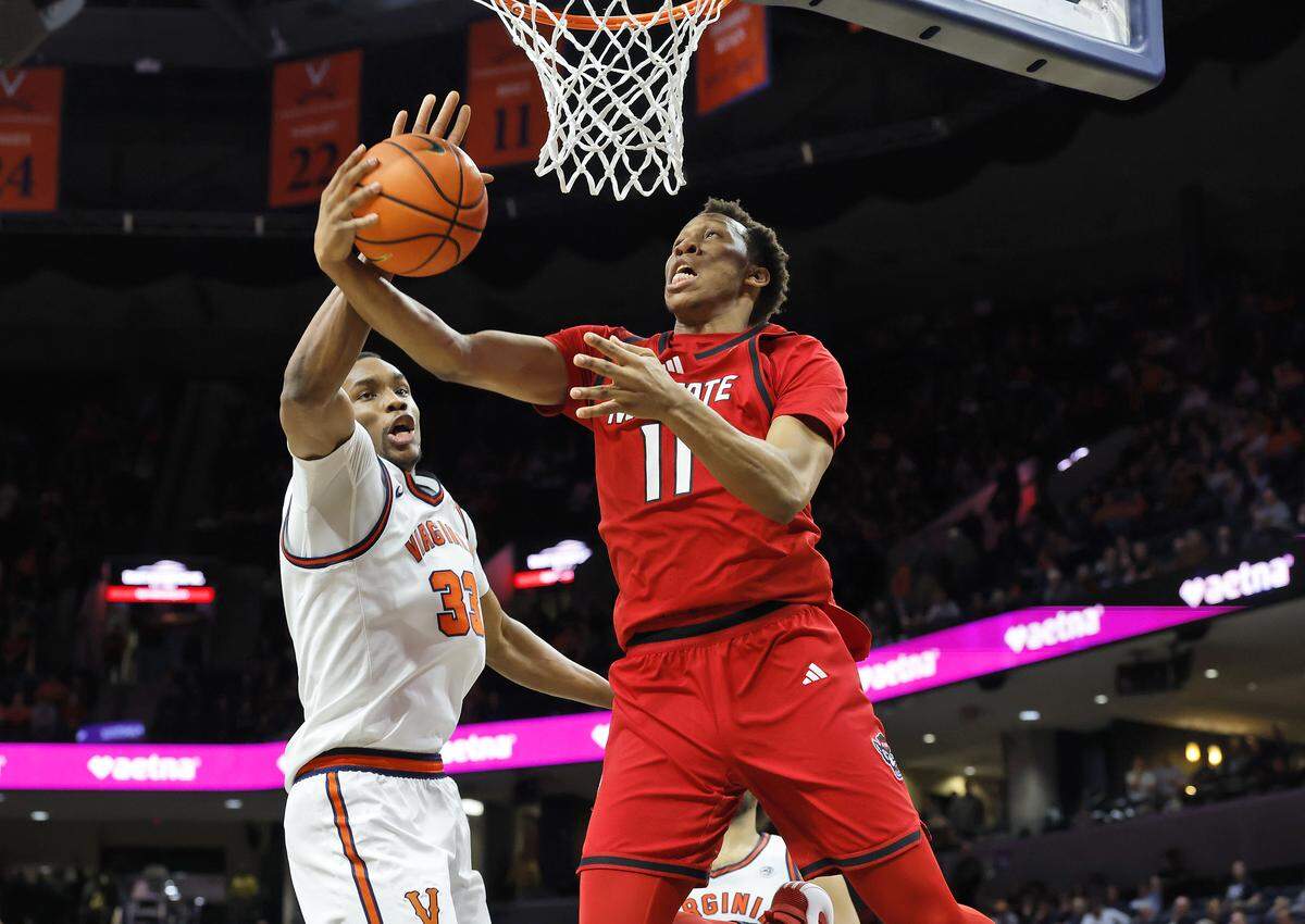 N.C. State's Quadir Copeland drives to the basket past Virginia's Ugonna Onyenso during the second half of the Wolfpack’s 90-61 loss on Thursday, Feb. 24, 2026, at John Paul Jones Arena in Charlottesville, Va. 