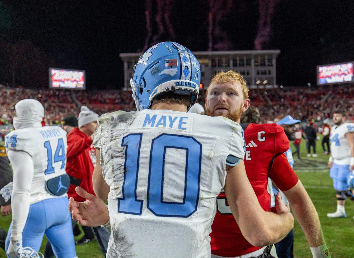 North Carolina quarterback Drake Maye (10) congratulates N.C. State quarterback Brennan Armstrong (5) following the Wolfpack’s 39-20 victory on Saturday, November 25, 2023 at Carter-Finley Stadium in Raleigh, N.C.
