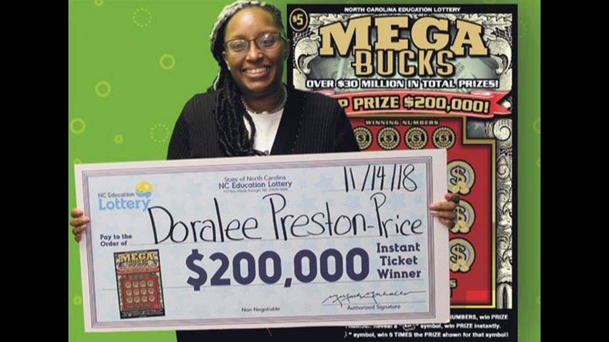 Doralee Preston-Price poses with her $200,000 check after buying a winning $5 Mega Bucks lottery ticket.