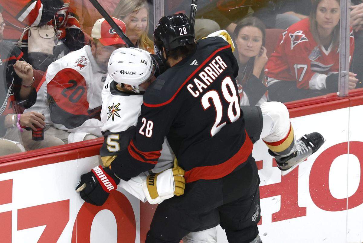 Carolina's William Carrier (28) checks Vegas' Jeremy Lauzon (5) during the first period of the Hurricanes’ game against the Golden Knights in the first game of the Stanley Cup Final at the Lenovo Center in Raleigh, N.C., Tuesday, June 2, 2026.