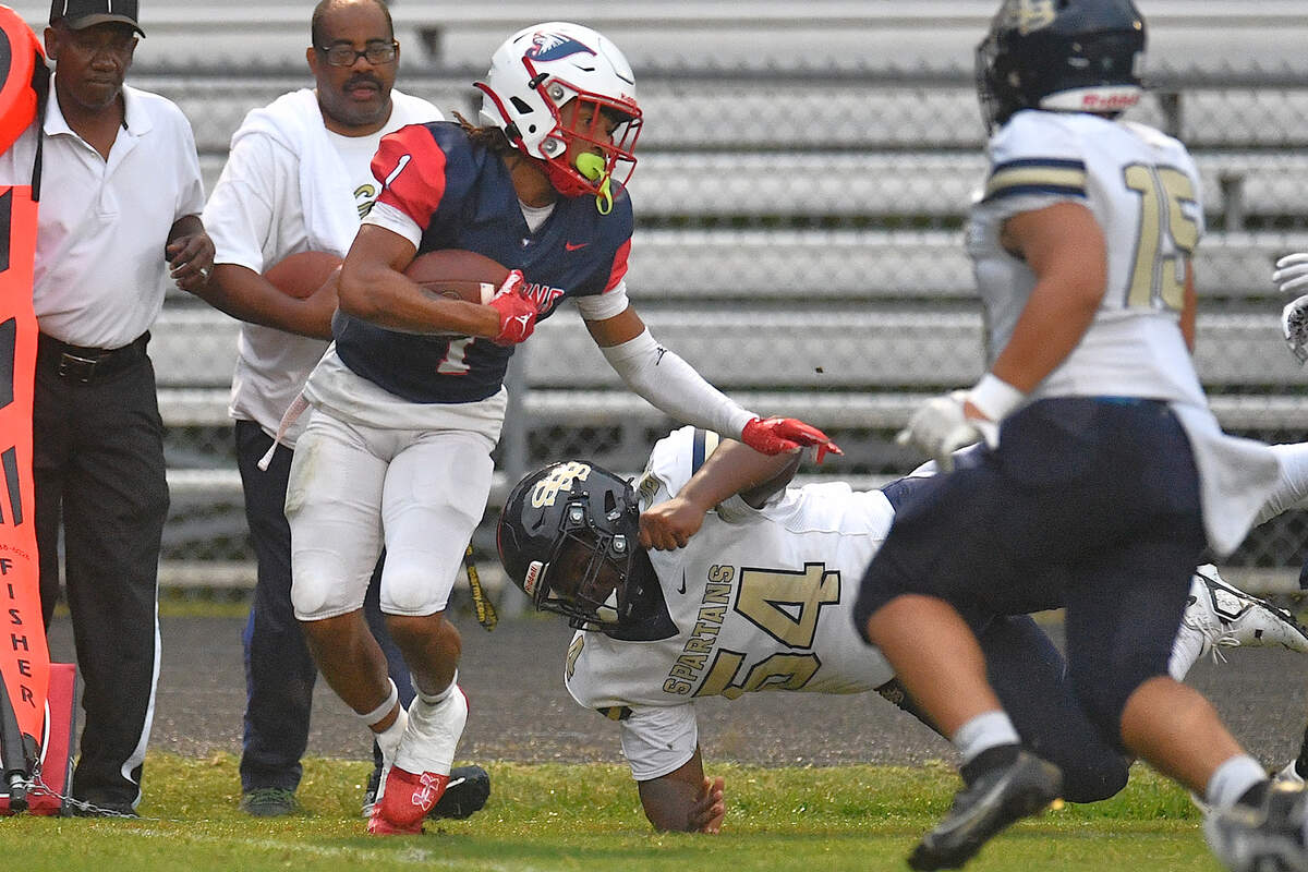 Jordan running back Omaris McMiller Jr. (1) runs for yardage against the sidelines against Smithfield-Selma defensive lineman Bryson Hinton (54) during the first half. The Durham Jordan Falcons and the Smithfield-Selma Spartans met in a football game in Durham, N.C. on September 13, 2024.