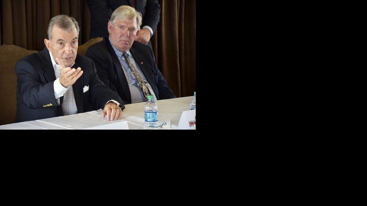 Carolina Mudcats owner Steve Bryant, right, looks on as Atlanta Braves President John Schuerholz fields questions on the Mudcats becoming the Major League team’s advanced Class A affiliate during a news conference Thursday at Five County Stadium in Zebulon.
