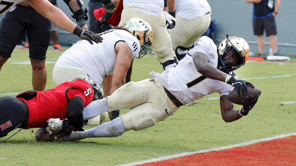 Wake Forest running back Demond Claiborne (1) scores on a three-yard touchdown run with one minute left in the game on the way to Wake Forest’s 34-30 victory over N.C. State at Carter-Finley Stadium in Raleigh, N.C., Saturday, Oct. 5, 2024.