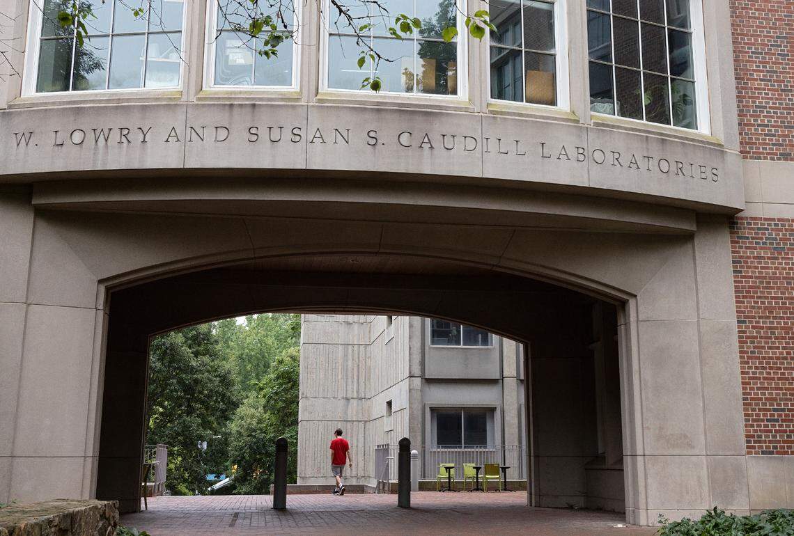 A person walks by Caudill Laboratories on the campus of UNC-Chapel Hill on Tuesday, Aug. 29, 2023. The building remains closed following a Monday shooting at the laboratories that left a member of the faculty dead.